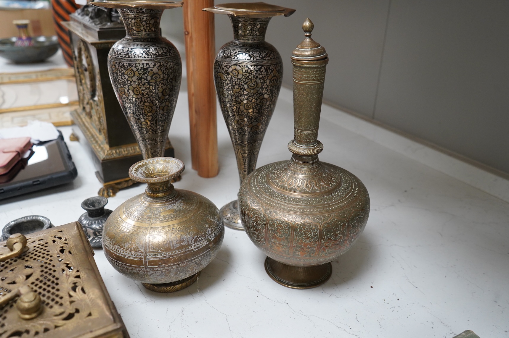 A collection of Indian brass and metalware to include a pierced casket box and Bidriware vases, largest 33cm high